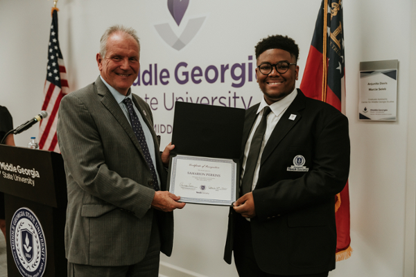 Samarion Perkins being inducted into the MGA President’s Torch Society.
